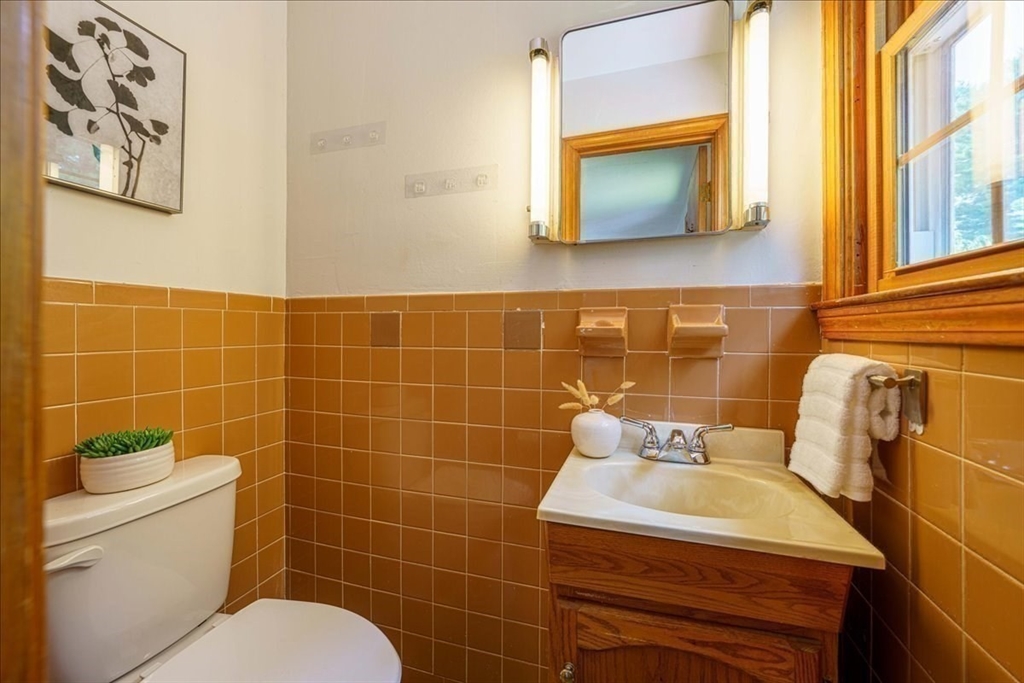 17 Coolidge Street Billerica, MA 01821 - Photo 17 of 32 a bathroom with a toilet sink and mirror