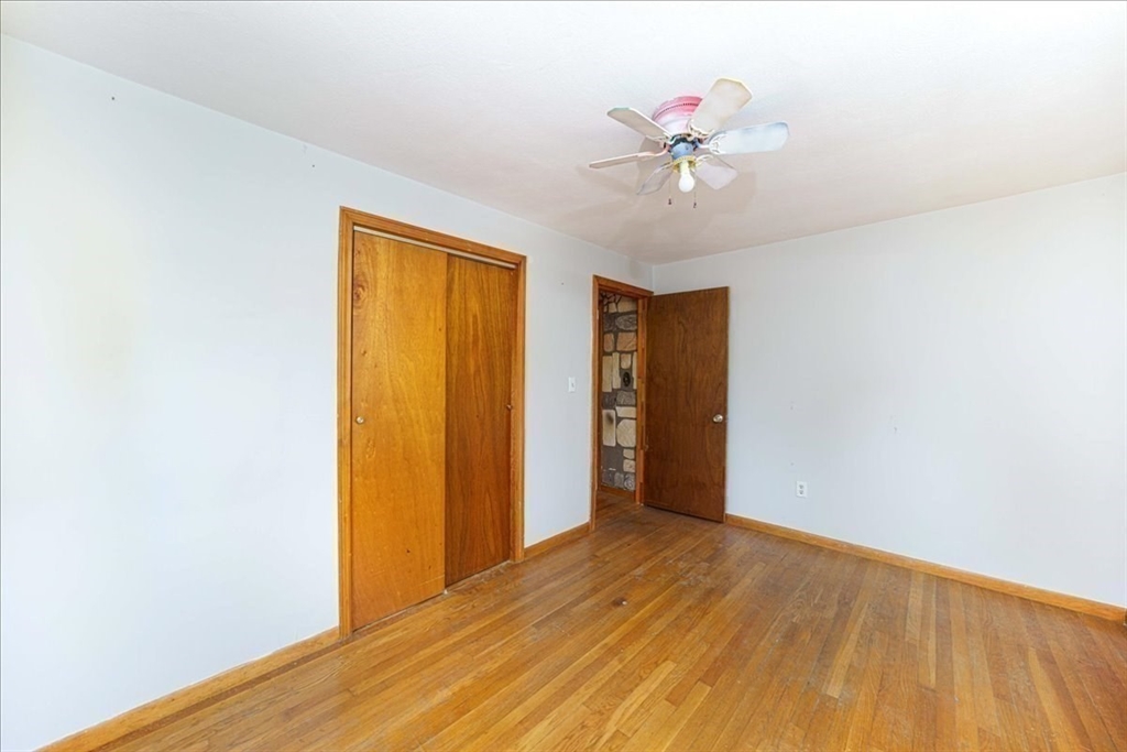 17 Coolidge Street Billerica, MA 01821 - Photo 20 of 32 a view of an empty room with wooden floor and a ceiling fan