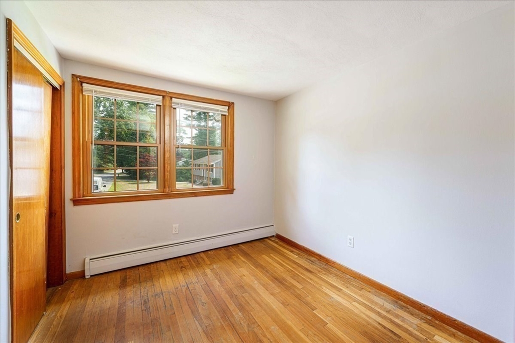 17 Coolidge Street Billerica, MA 01821 - Photo 21 of 32 an empty room with wooden floor and windows