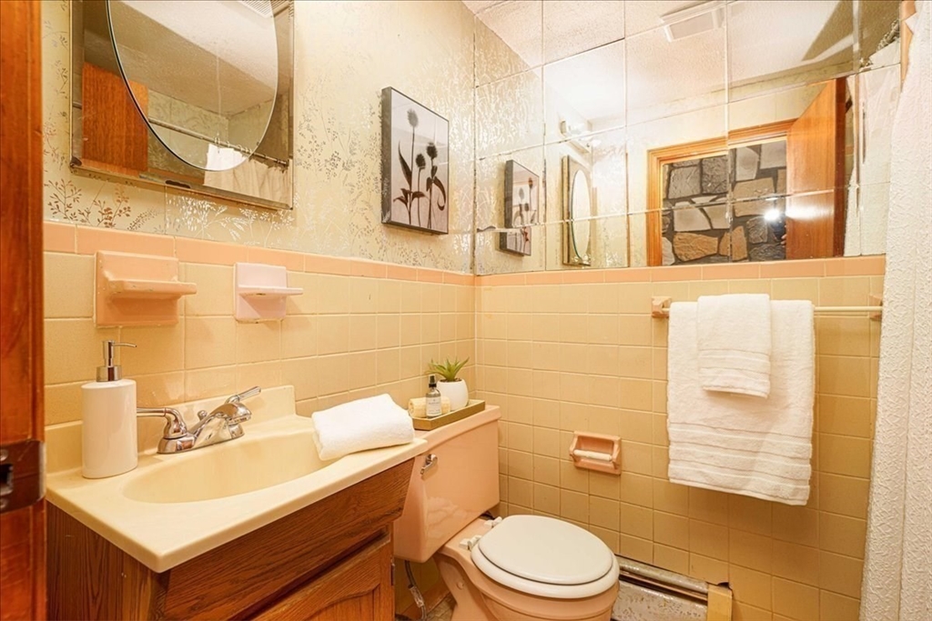 17 Coolidge Street Billerica, MA 01821 - Photo 22 of 32 a bathroom with a sink mirror vanity and toilet