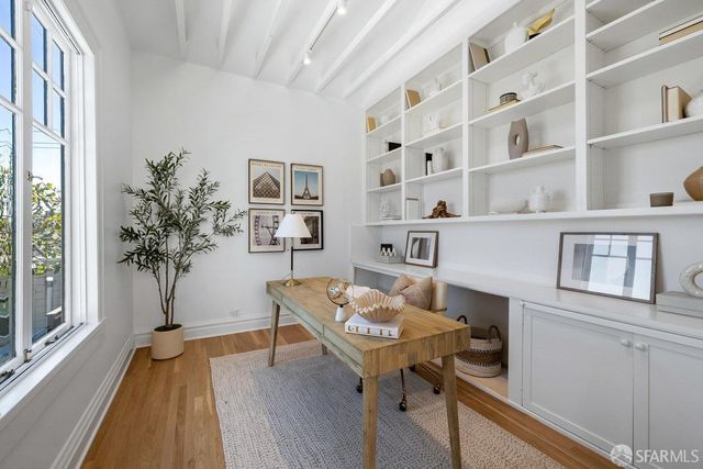 a view of a workspace with furniture and a potted plant