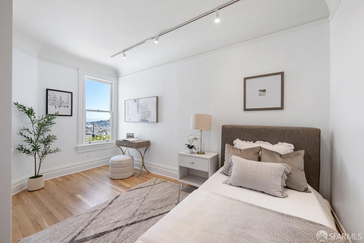 115 Hoffman San Francisco, CA 94114 - Photo 26 of 44 a bedroom with a large bed and a potted plant