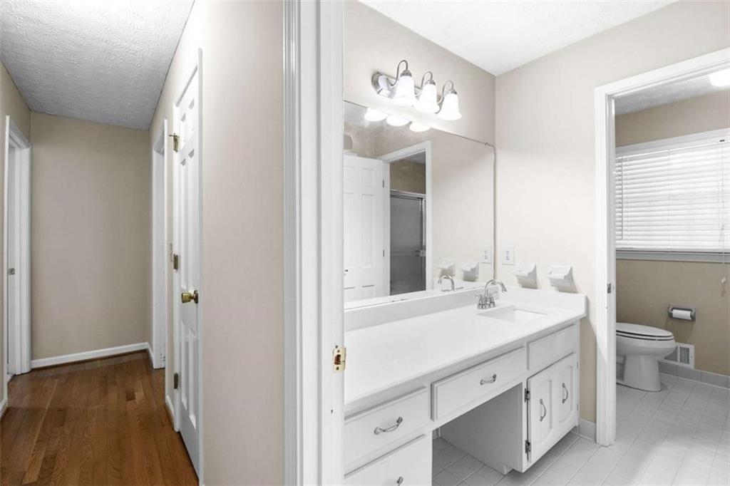 2678 North Bogan Road Northeast Buford, GA 30519 - Photo 13 of 52 a bathroom with a double vanity sink and a mirror