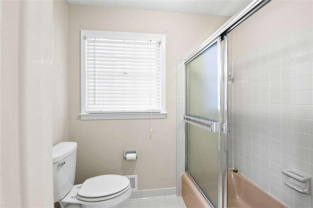 2678 North Bogan Road Northeast Buford, GA 30519 - Photo 14 of 52 a bathroom with a toilet and a shower