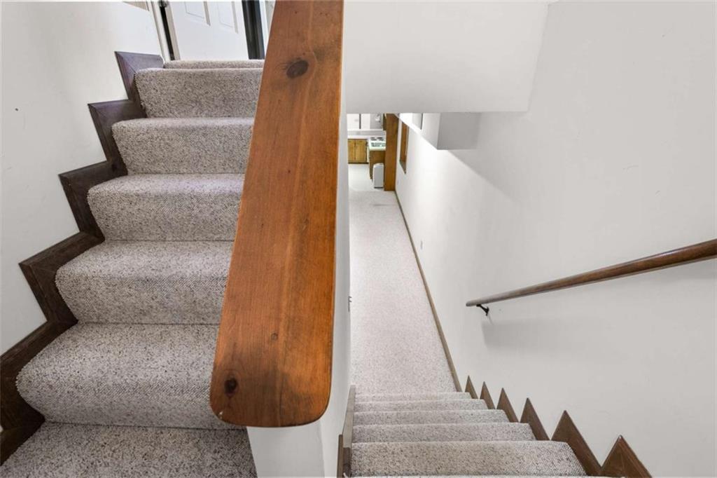 2678 North Bogan Road Northeast Buford, GA 30519 - Photo 20 of 52 a living room with furniture and stairs