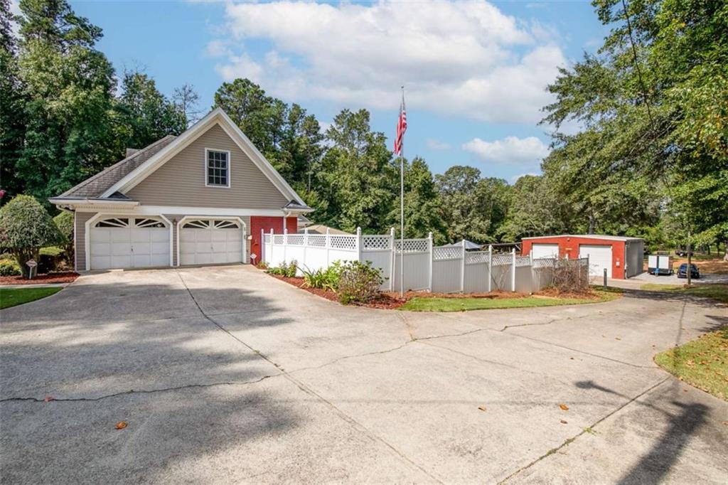 2678 North Bogan Road Northeast Buford, GA 30519 - Photo 30 of 52 a view of a house with a yard and large trees