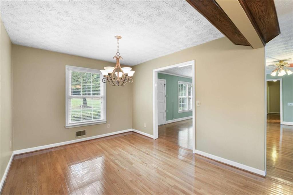2678 North Bogan Road Northeast Buford, GA 30519 - Photo 31 of 52 a view of an empty room with wooden floor and a window