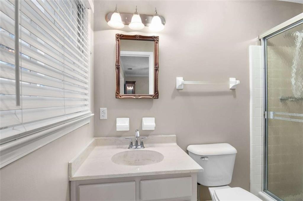 2678 North Bogan Road Northeast Buford, GA 30519 - Photo 33 of 52 a bathroom with a sink toilet and mirror