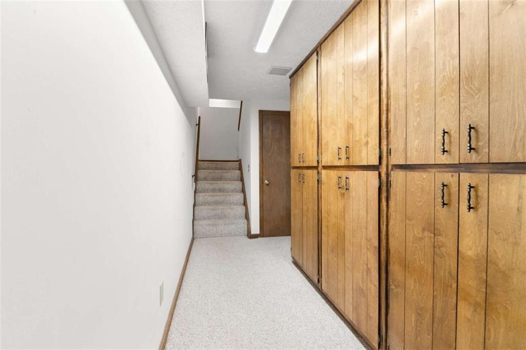 2678 North Bogan Road Northeast Buford, GA 30519 - Photo 39 of 52 a view of a hallway with wooden floor and staircase