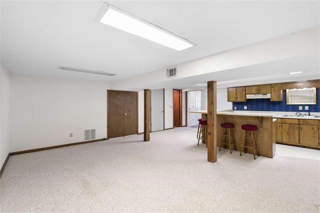 2678 North Bogan Road Northeast Buford, GA 30519 - Photo 42 of 52 a view of a livingroom with furniture and a kitchen