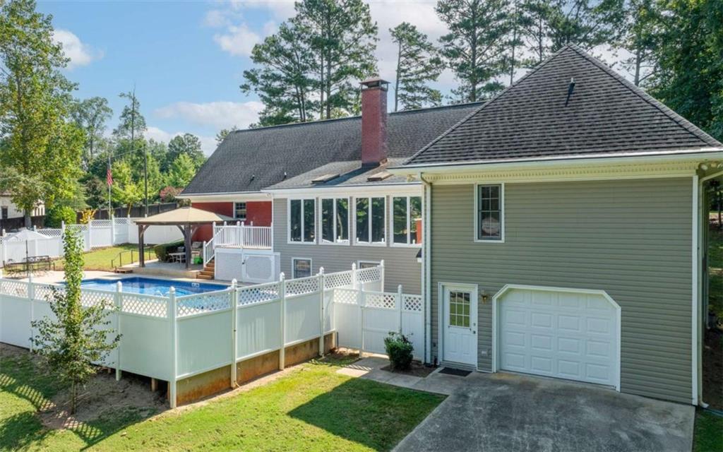 2678 North Bogan Road Northeast Buford, GA 30519 - Photo 44 of 52 a front view of a house with a garden and trees