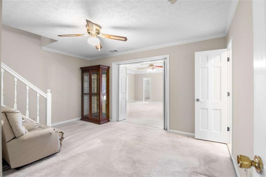 2678 North Bogan Road Northeast Buford, GA 30519 - Photo 50 of 52 a living room with furniture and a ceiling fan