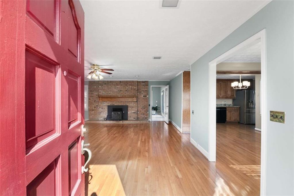 2678 North Bogan Road Northeast Buford, GA 30519 - Photo 10 of 52 a view of a livingroom with wooden floor and a fireplace