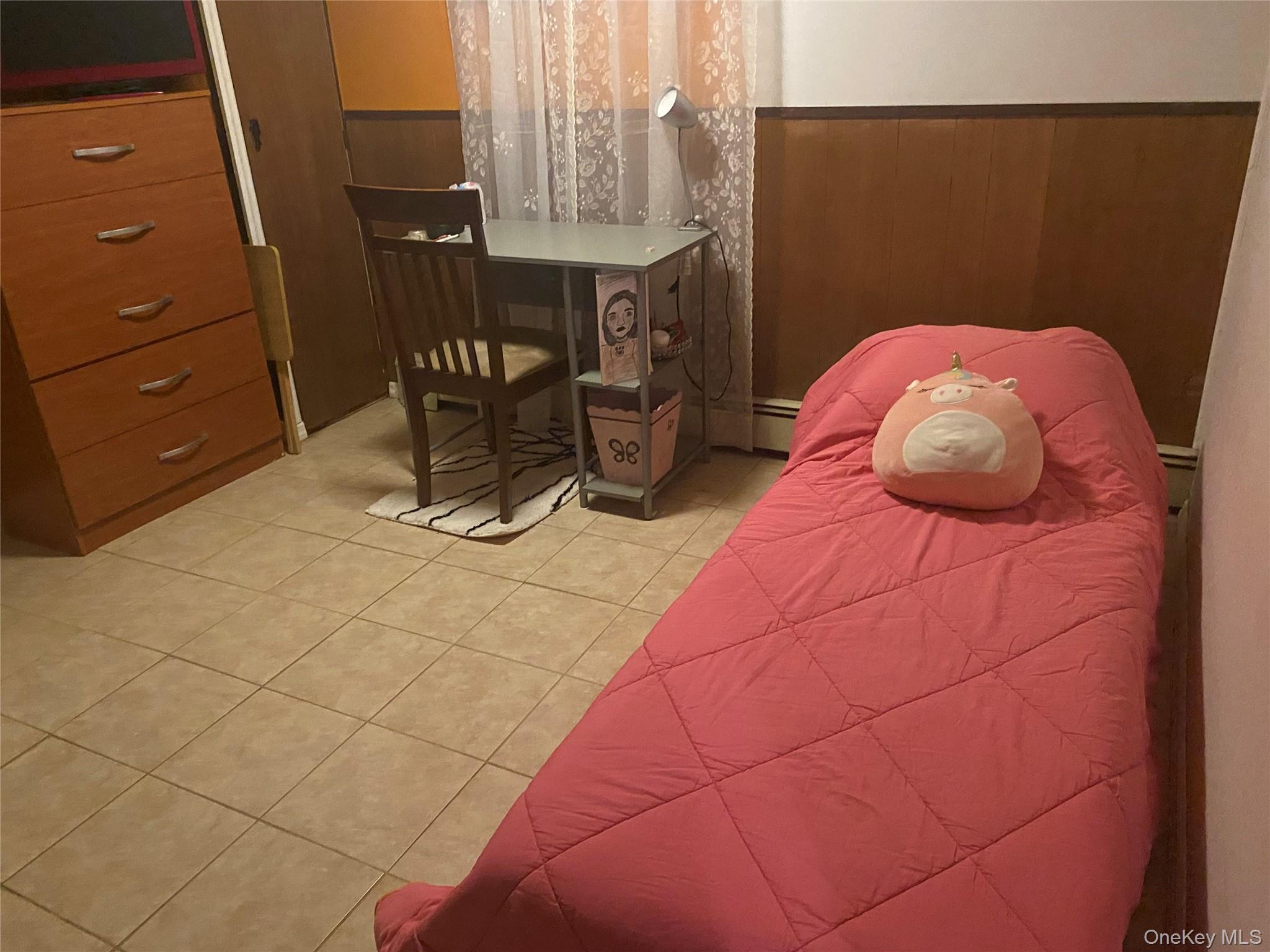 204 Beech Street Valley Stream, NY 11580 - Photo 11 of 18 a bedroom with a bed and a table