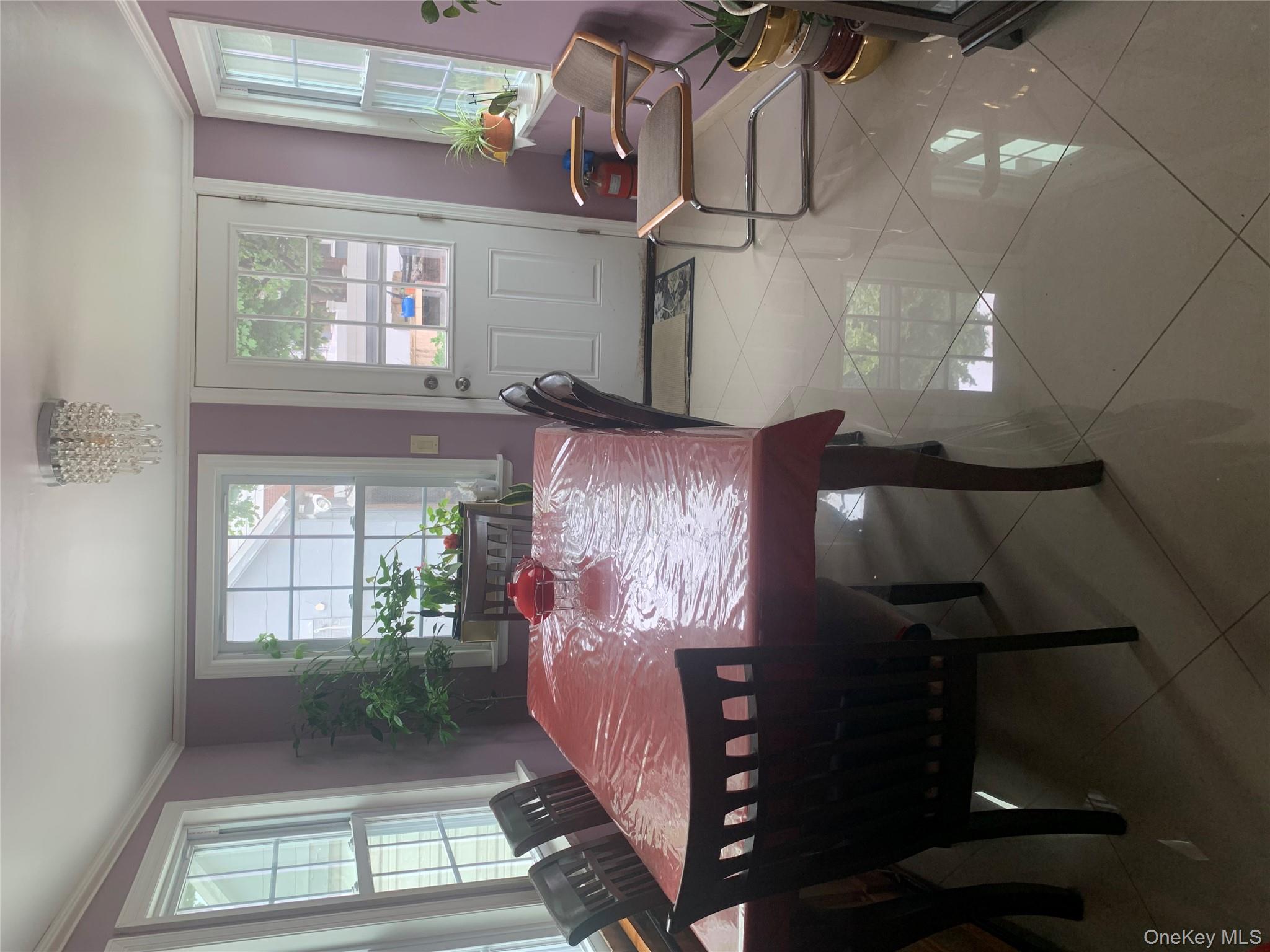 204 Beech Street Valley Stream, NY 11580 - Photo 16 of 18 a view of a dining room with furniture window and outside view