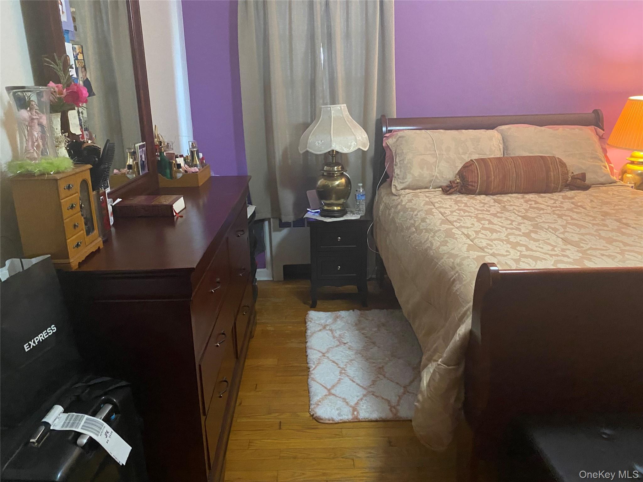 204 Beech Street Valley Stream, NY 11580 - Photo 6 of 18 a bedroom with a bed and a chandelier