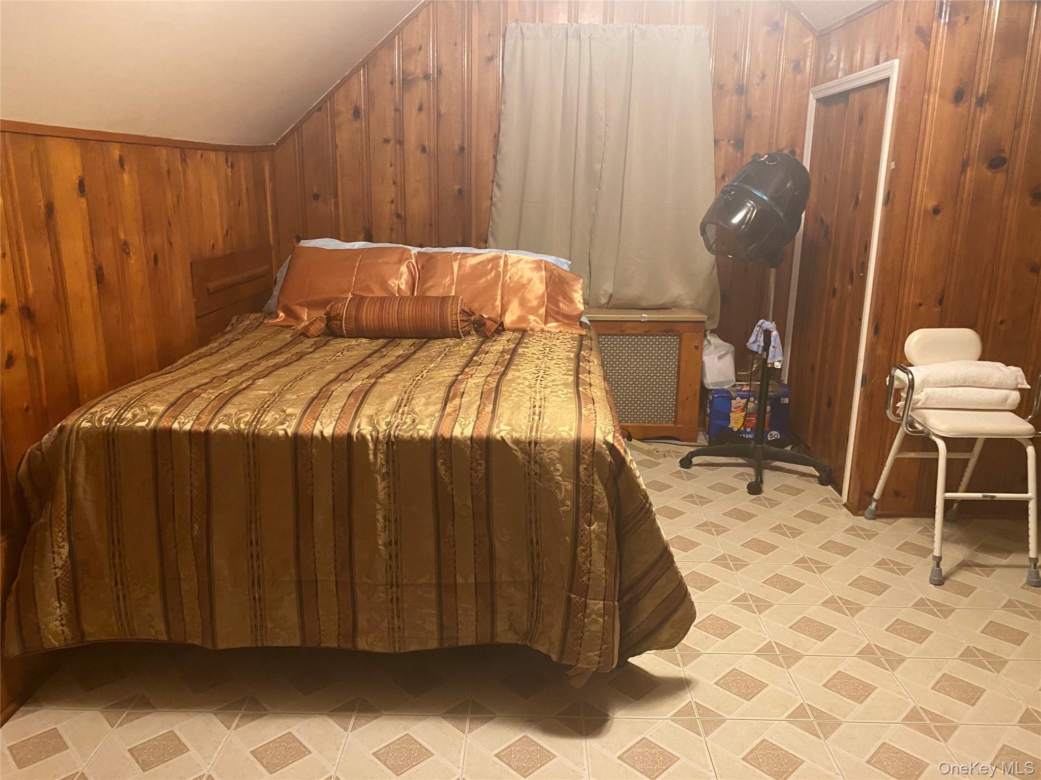 204 Beech Street Valley Stream, NY 11580 - Photo 7 of 18 a bedroom with a bed and a chair