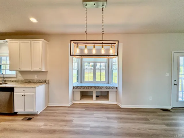 a view of a kitchen with a sink and wooden floor