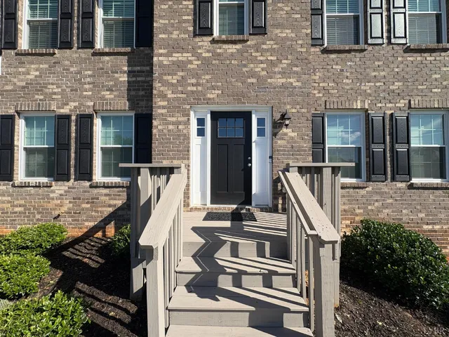 a view of a brick house with a large windows