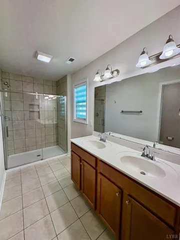a bathroom with a shower sink and mirror