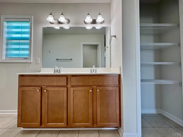 a bathroom with a sink vanity and a mirror