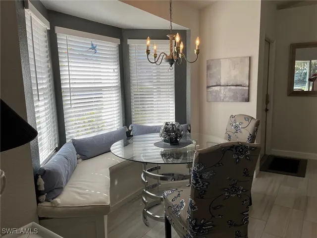 a dining room with furniture and window