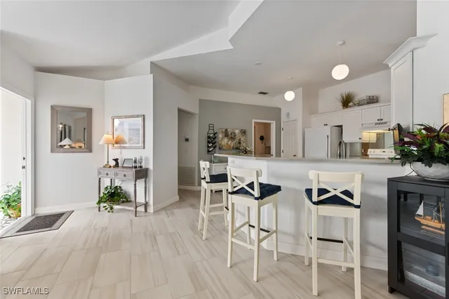 a view of living room kitchen with furniture and wooden floor