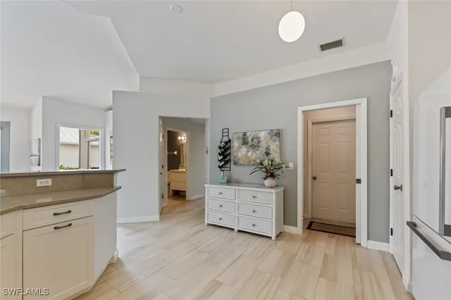 a view of kitchen with granite countertop cabinets and sink