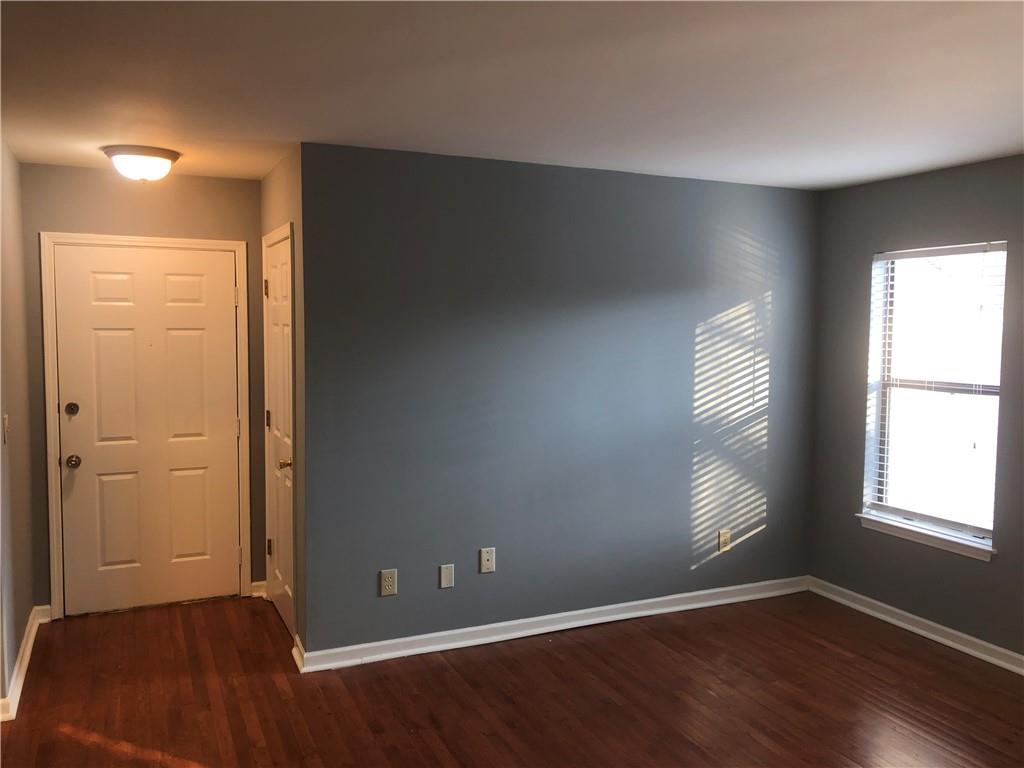 2213 Huntingdon Chase Atlanta, GA 30350 - Photo 1 of 1 an empty room with wooden floor and windows