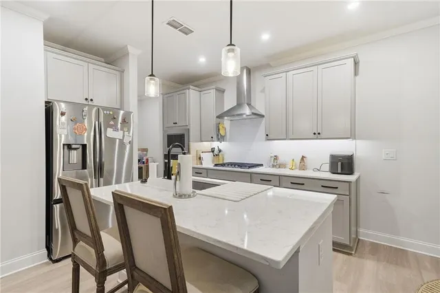 a bathroom with a toilet a sink a mirror a bathtub and vanity