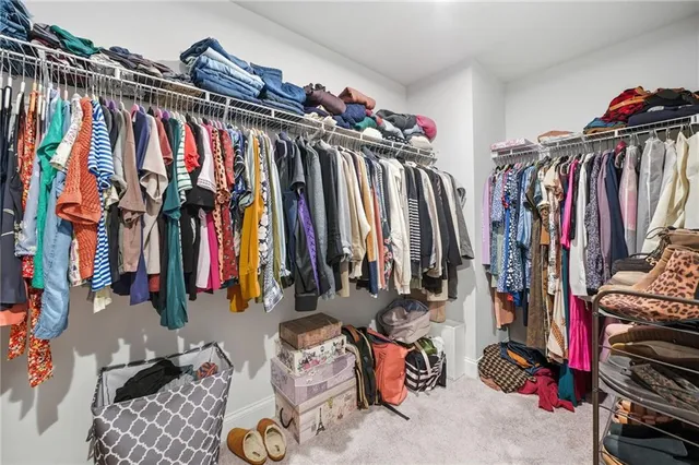a view of backyard with wooden fence and large trees