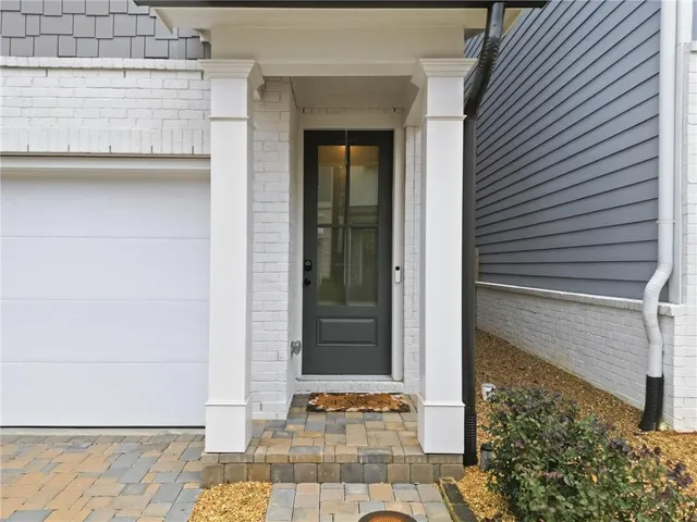 an aerial view of a house with outdoor space and a lake view