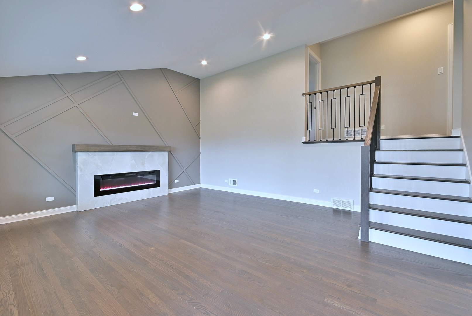 8218 Linder Avenue Burbank, IL 60459 - Photo 4 of 23 an empty room with wooden floor fireplace and windows