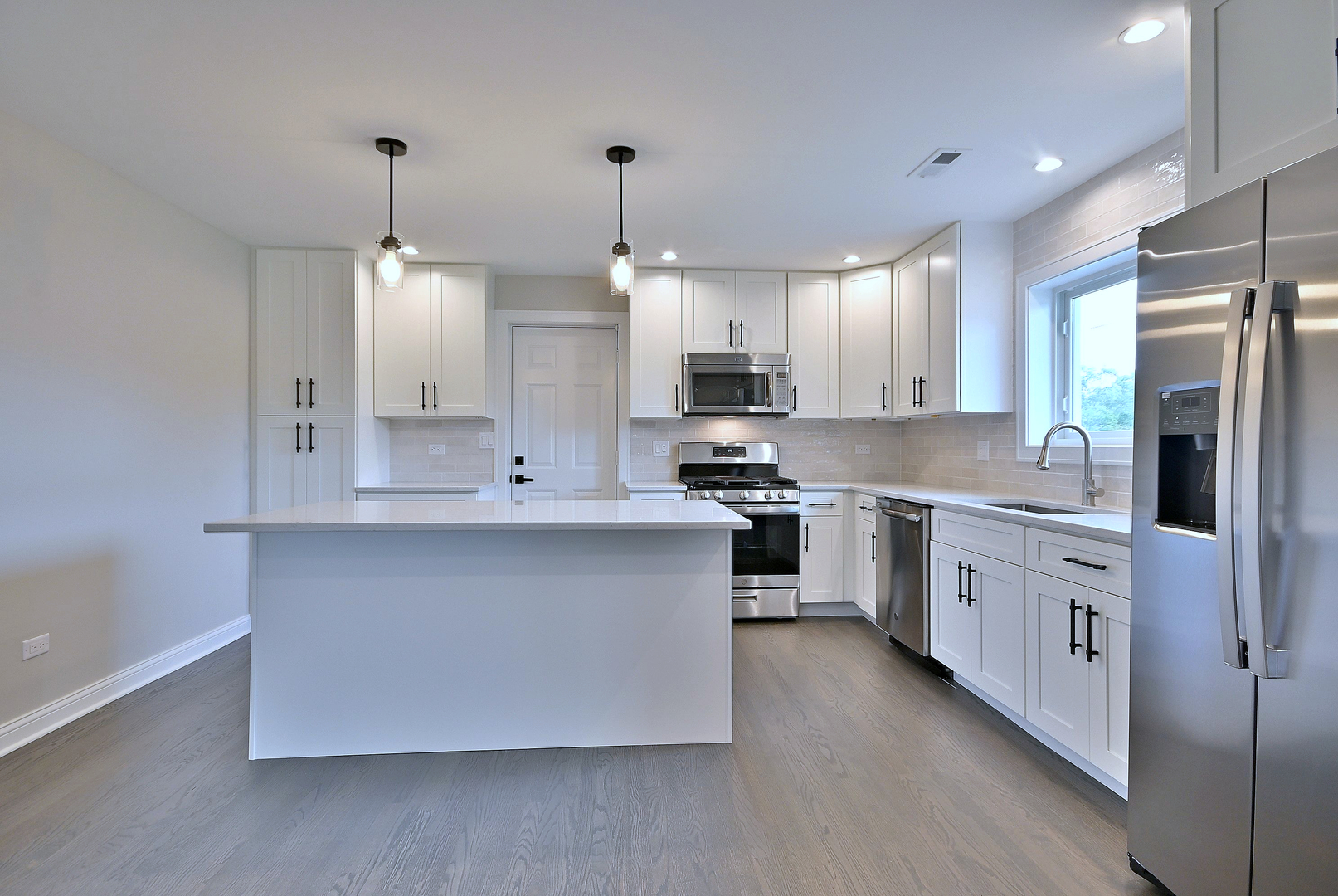 8218 Linder Avenue Burbank, IL 60459 - Photo 9 of 23 a large kitchen with stainless steel appliances a sink a stove and a refrigerator