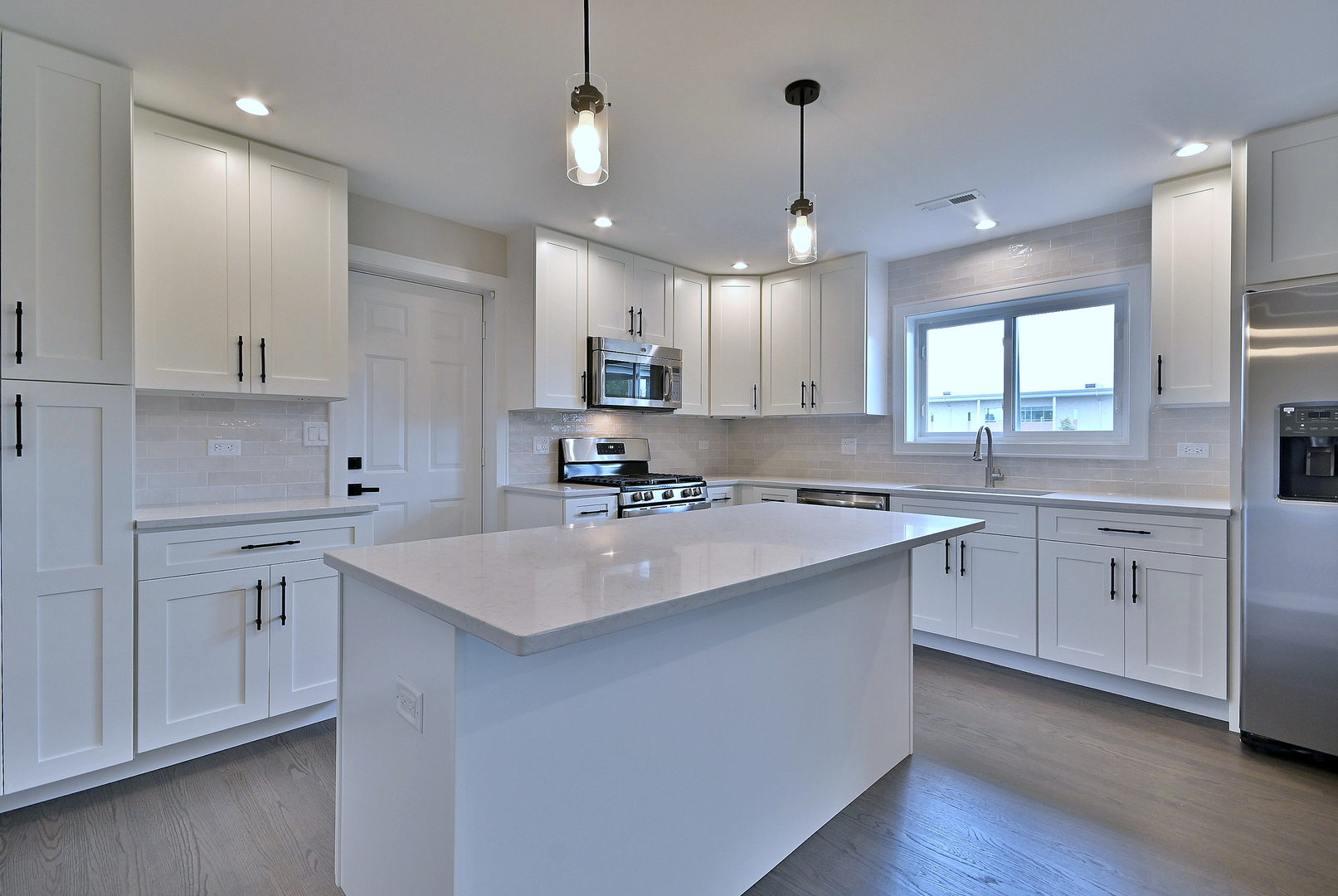 8218 Linder Avenue Burbank, IL 60459 - Photo 10 of 23 a kitchen with kitchen island white cabinets appliances and a sink