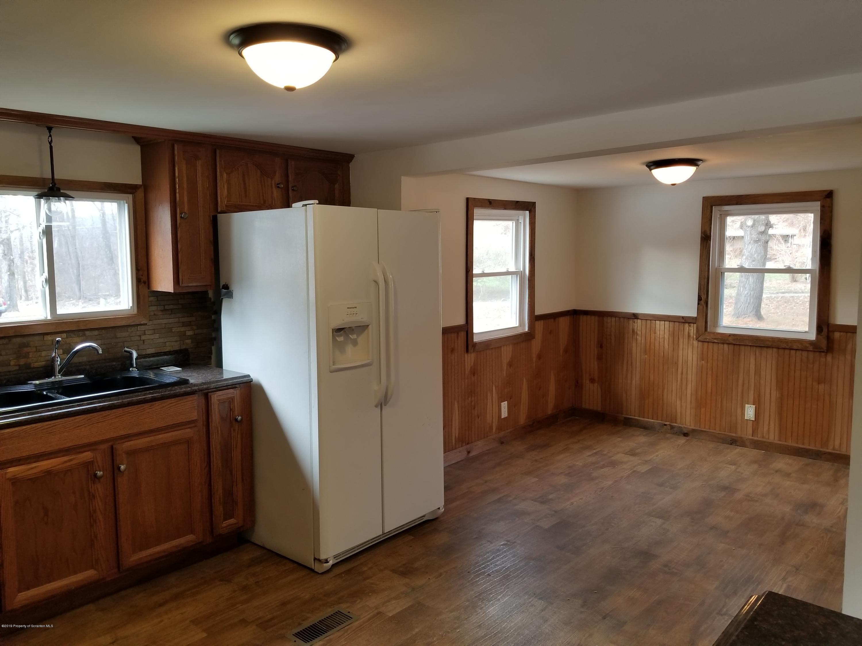 268 State Rte 4013 Little Meadows, PA 18830 - Photo 32 of 48 a kitchen with granite countertop a refrigerator and a sink