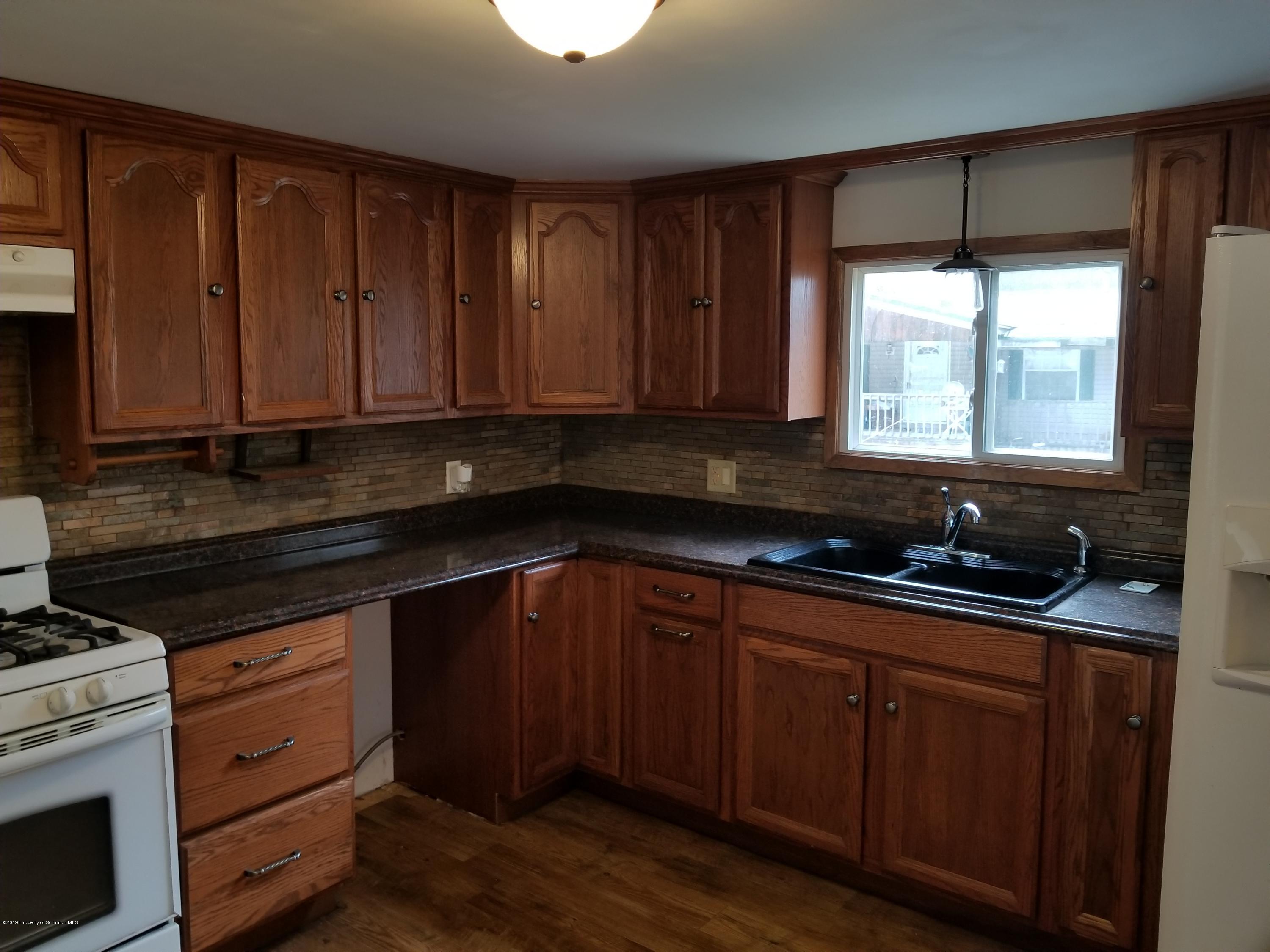 268 State Rte 4013 Little Meadows, PA 18830 - Photo 34 of 48 a kitchen with granite countertop wooden cabinets and a stove top oven