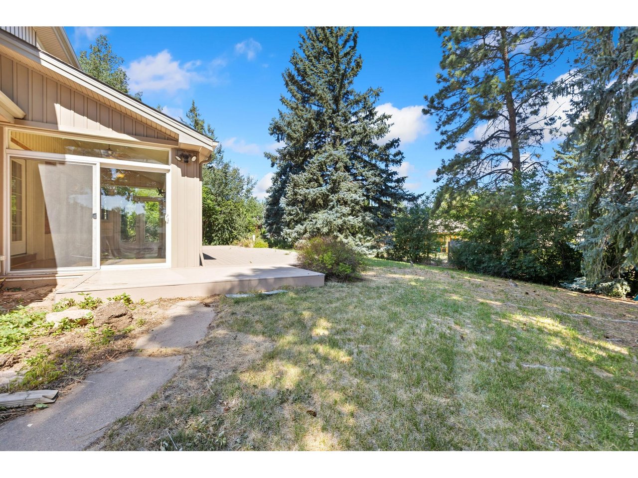 2121 18th Street Road Greeley, CO 80631 - Photo 34 of 40 Side slider from the enclosed porch to the back yard.