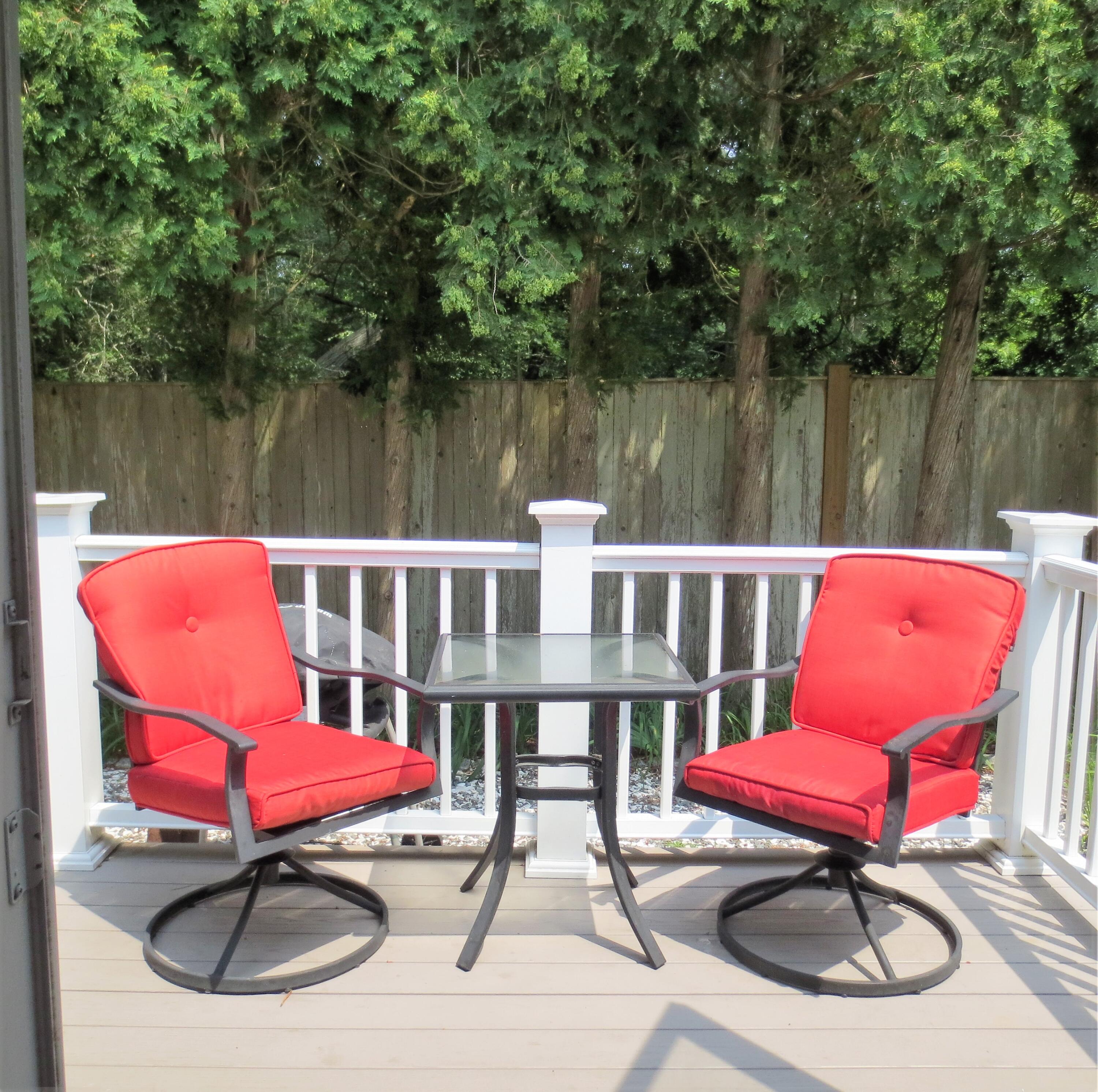 558 Craigville Beach Road, Unit 9 Centerville, MA 02632 - Photo 30 of 35 a balcony with wooden floor table and chairs