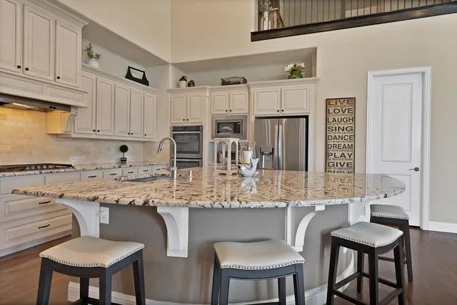a kitchen with stainless steel appliances granite countertop a sink and cabinets