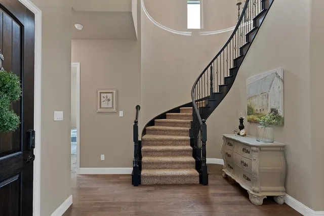 a view of entryway with wooden floor and stairs