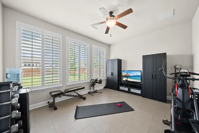 a bedroom with furniture and a flat screen tv