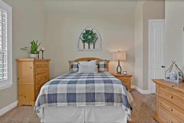 a bedroom with a bed and a dresser