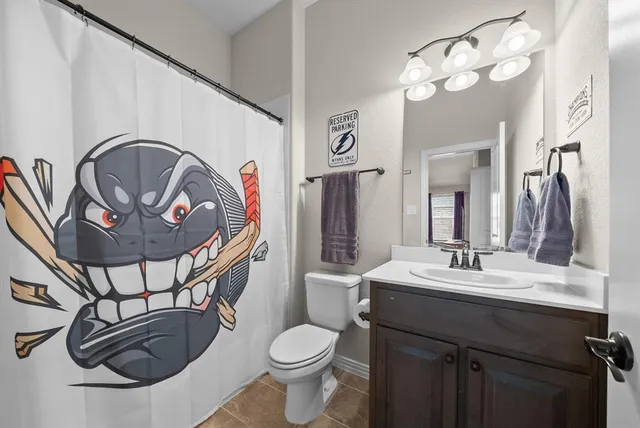 a bathroom with a sink a mirror and a toilet