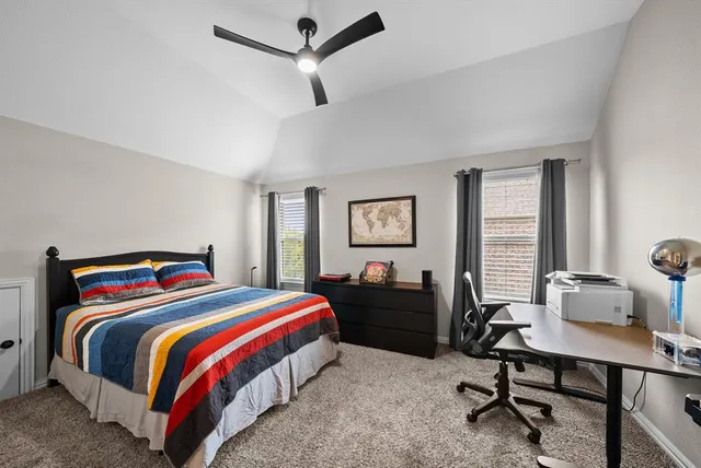 a bedroom with a bed and a table in it