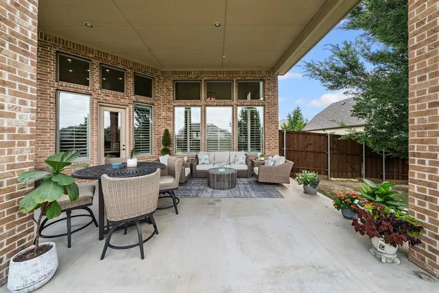 a building outdoor space with patio furniture and potted plants