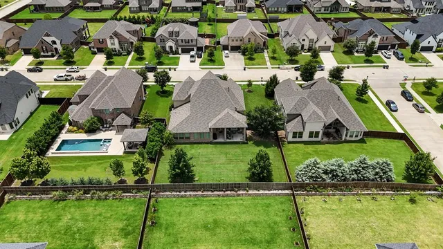 an aerial view of multiple houses with yard