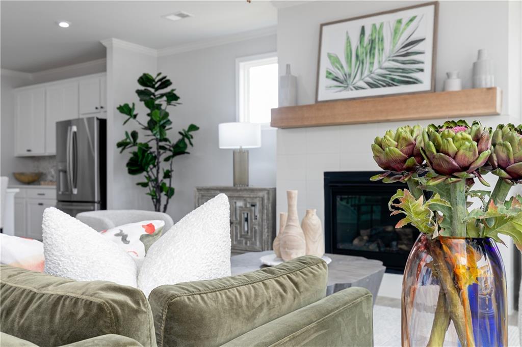 862 Leraes Way Loganville, GA 30052 - Photo 16 of 56 a living room with furniture flowerpot and a chandelier