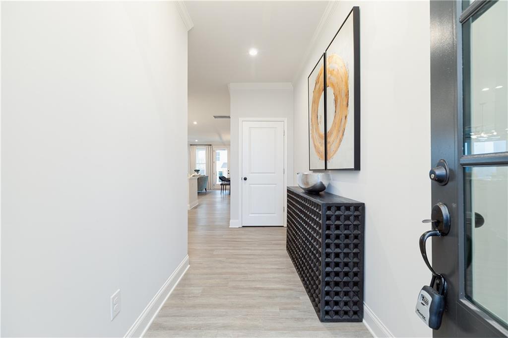 862 Leraes Way Loganville, GA 30052 - Photo 2 of 56 a view of a hallway with wooden floor and furniture