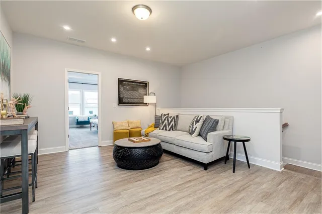 a living room with furniture and a wooden floor